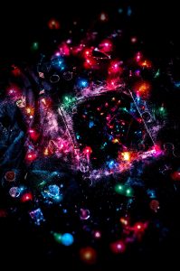 A dark room with an array of colored lights reflected in a mirror